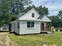 Charming home featuring a quaint covered porch and a well-maintained lawn at 1336 Hill St, Rocky Mount, NC 27801
