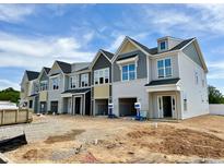 New construction townhomes boast multi-tone exterior paint, individual garages, and modern architectural design at 154 Ripple Way # 320, Clayton, NC 27520