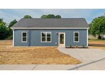 Charming single story home featuring a concrete driveway and minimalist landscaping at 19 Southern Village Dr, Roxboro, NC 27573