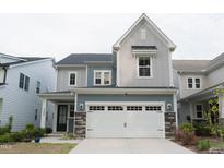 Charming two-story home with a two-car garage and stone accents at 2089 Florine Dr, Apex, NC 27502
