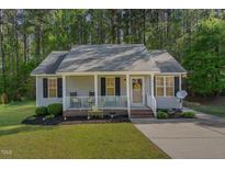 Charming single-story home with a cozy front porch and well-maintained landscaping at 2112 Ballston Pl, Knightdale, NC 27545