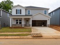 Two-story home features gray siding, dark shutters, a large garage, and a well-manicured lawn at 2214 Cherry Creek Rd, Haw River, NC 27258
