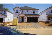 New home construction in progress with Tyvek house wrap and a portable toilet in the front yard at 2218 Cherry Creek Rd, Haw River, NC 27258