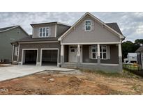 Charming two-story home showcasing a spacious two-car garage and inviting front porch at 2320 Eagle Shot Ct # 20, Fuquay Varina, NC 27526