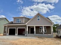 New two-story home with a two-car garage, covered porch, and neutral brown and gray color scheme at 2320 Eagle Shot Ct # 20, Fuquay Varina, NC 27526