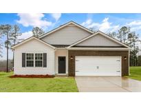 Charming single-Gathering home showcasing a brick and vinyl exterior with a two-car garage at 2736 Luxborough Ln, Mebane, NC 27302