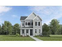 Charming two-story home with a gray exterior, black shutters, stone accents, and lush green landscaping at 320 Canyon Spring Trl, Wake Forest, NC 27587