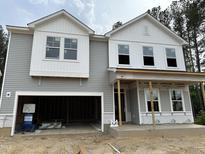 New two-story home showing gray siding, white trim, and an attached two-car garage at 4008 Shadbush St, Raleigh, NC 27616