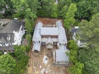 Expansive new construction featuring a brick facade, detailed roofline, and lush surrounding greenery at 516 Transylvania Ave, Raleigh, NC 27609