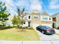 Inviting two-story home with a stone facade, attached garage, and well-manicured lawn at 5410 Jessip Street St, Morrisville, NC 27560