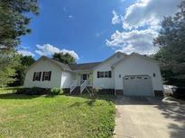 Charming single-story home with white siding, well-maintained lawn, and attached two-car garage at 547 Coharie Dr, Wendell, NC 27591