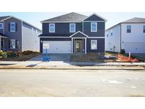 Charming two-story home with a two-car garage and a well-maintained lawn at 630 White Birch Ln, Angier, NC 27501
