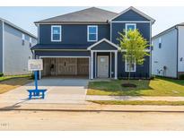 Charming two-story home with a front yard, spacious garage, and classic design at 630 White Birch Ln, Angier, NC 27501