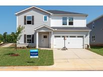 Charming two-story home with a two-car garage, neutral siding, and well-maintained landscaping at 728 Deschutes Dr, Garner, NC 27529