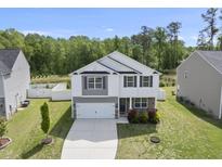 Charming two-story home with a two car garage, complemented by a beautifully landscaped yard at 115 Zulabelle Ct, Garner, NC 27529