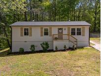 Charming single-story home with wood shutters, a well-maintained lawn and refreshed landscaping at 120 King Charles Rd, Hillsborough, NC 27278