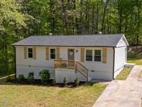 Charming ranch-style home featuring light siding, complementary shutters, and a quaint front porch at 120 King Charles Rd, Hillsborough, NC 27278