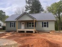Charming single story home with a metal roof, black shutters, and unfinished front yard at 2230 Burch Bridge Rd, Burlington, NC 27217