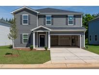 Charming two-story home features a well-kept lawn and an attached two-car garage at 2239 Cherry Creek Rd, Haw River, NC 27258