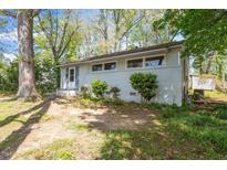 A charming single-story house with a brick facade and mature trees in the front yard at 2343 Derby Dr, Raleigh, NC 27610