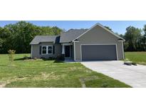 New construction home featuring a two-car garage, neutral siding, and a well-manicured lawn at 261 Phil Jack Rd, Dunn, NC 28334