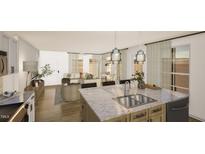 Bright, open kitchen boasts a large island with marble countertops, pendant lighting, and stainless steel appliances at 307 Burke St, Dunn, NC 28334