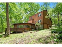 A beautiful two-story home nestled among lush trees creating a private, wooded setting at 3605 Moonlight Dr, Chapel Hill, NC 27516