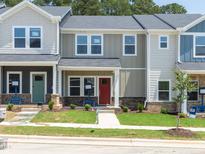 Charming townhomes featuring craftsman-style architecture, covered entryways, and well-manicured lawns create inviting curb appeal at 3705 Rosebush Dr, Zebulon, NC 27597