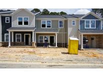 New townhomes featuring modern designs, varied color palettes and construction in progress at 3705 Rosebush Dr, Zebulon, NC 27597