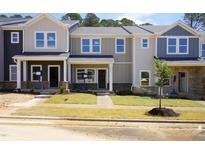 New townhomes feature mulitple stories, well kept yards, and covered porches at 3705 Rosebush Dr, Zebulon, NC 27597