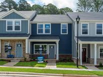 Charming townhomes with blue siding, brick accents, and well-maintained front yards at 3709 Rosebush Dr, Zebulon, NC 27597