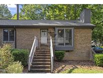 Charming brick home featuring a welcoming entrance with well-maintained landscaping at 500 W Woodcroft Pkwy # 13D, Durham, NC 27713