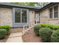 Charming brick home featuring a welcoming front entrance with well-maintained landscaping at 500 W Woodcroft Pkwy # 17C, Durham, NC 27713