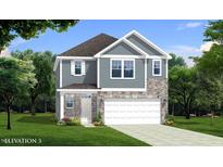 Charming two-story home features a stone and siding facade, green lawn and attached two car garage at 1003 Shovelhead Dr # 2, Durham, NC 27703