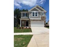 Two-story home featuring a two-car garage, stone accents, gray siding, and a well-manicured front yard at 1003 Shovelhead Dr # 2, Durham, NC 27703