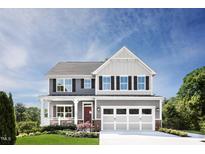 Beautiful two-story home with a manicured lawn, covered porch, and attached two-car garage at 1044 Country Pasture Cv, Wendell, NC 27591