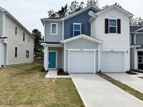 Charming two-story townhome with attached garage and well-manicured lawn at 10527 Brookside Reserve Rd, Raleigh, NC 27614