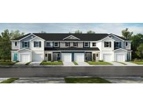 Charming townhomes with white and blue exteriors, complemented by well-manicured lawns and driveways at 10527 Brookside Reserve Rd, Raleigh, NC 27614
