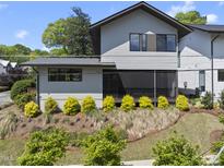 Charming two-story home with grey siding, complemented by well-maintained landscaping at 1101 Norris St, Raleigh, NC 27604