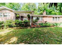 Charming brick home with a covered porch and well-maintained landscaping, creating a welcoming curb appeal at 2307 Piedmont Dr, Sanford, NC 27330