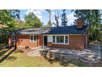 Charming brick home with a dark roof, stone accents, updated windows and landscaping at 2605 Joe Pruitt Rd, Oxford, NC 27565