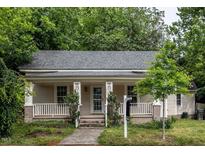 Charming single-story home featuring a cozy front porch, well-maintained lawn, and mature trees at 305 Freeman St, Raleigh, NC 27601