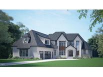Elegant two-story home boasts a stone and siding facade, accented by a welcoming arched entry and three-car garage at 3608 Cobbler Vw Way, Fuquay Varina, NC 27526