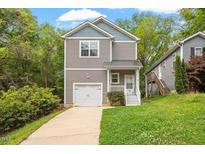 Charming two-story home with a one-car garage and beautifully landscaped front yard at 419 E East Hinton St, Clayton, NC 27520