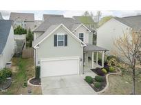 Charming home features a front-facing garage, covered porch, and manicured landscaping at 45 Davelyn Ct, Garner, NC 27529