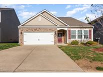 Charming single-Gathering home featuring stone accents, a two-car garage and manicured landscaping at 46 S Great White Way, Clayton, NC 27527