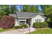 Charming single-story home featuring a cozy front porch and well-maintained landscaping with shrubs and a decorative yard at 508 2Nd Street St, Apex, NC 27502
