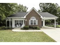 Charming brick and siding home featuring a well-manicured lawn and an inviting carport at 732 Westview Ct, Nashville, NC 27856