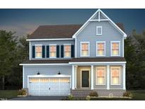 Charming two-story home featuring a symmetrical facade, welcoming front porch, and attached two-car garage at 755 Bachelor Gulch Way, Apex, NC 27523