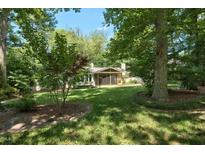 Beautiful backyard with a lush lawn, mature trees, and a screened-in porch for outdoor enjoyment at 9 Kimberly Dr, Durham, NC 27707